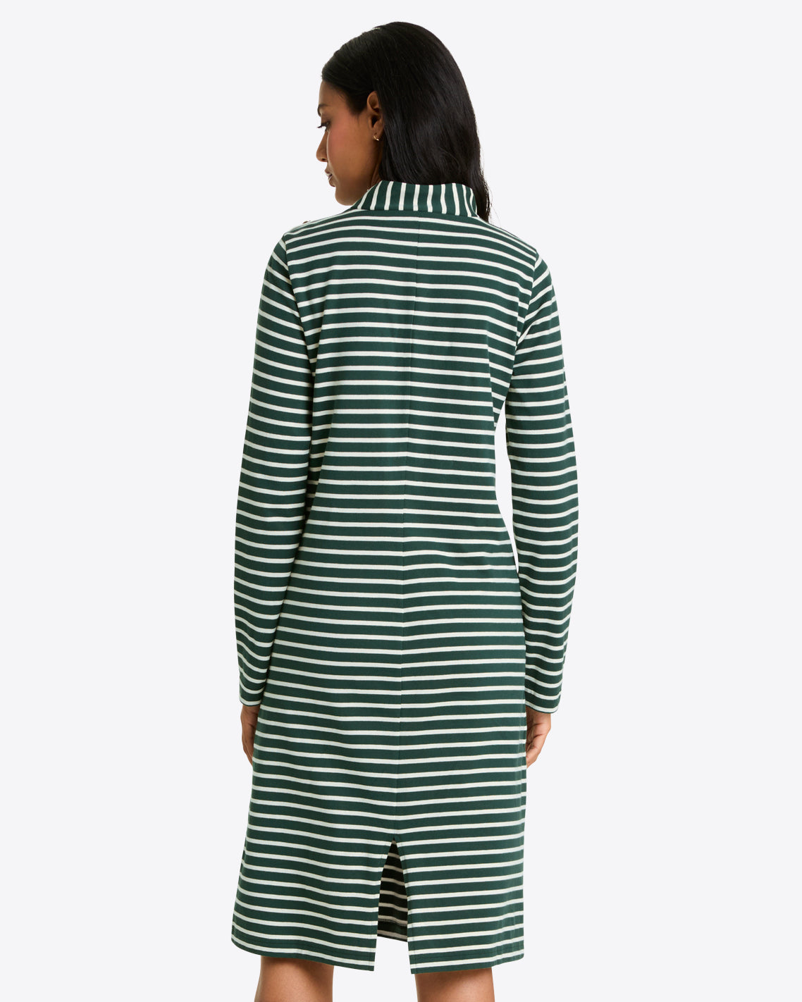 A woman is seen from behind wearing the Draper James Elsie Turtleneck Dress in Green Stripe—a knee-length, long-sleeved cotton jersey dress with a collar and back slit.
