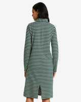 A woman is seen from behind wearing the Draper James Elsie Turtleneck Dress in Green Stripe—a knee-length, long-sleeved cotton jersey dress with a collar and back slit.