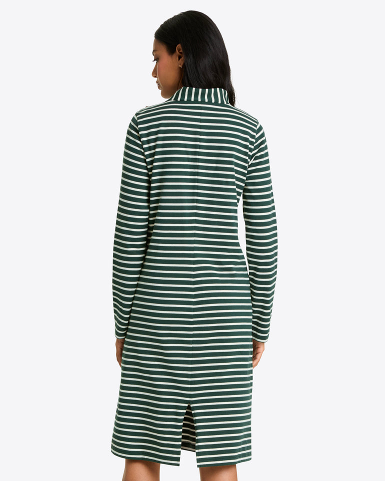 A woman is seen from behind wearing the Draper James Elsie Turtleneck Dress in Green Stripe—a knee-length, long-sleeved cotton jersey dress with a collar and back slit.