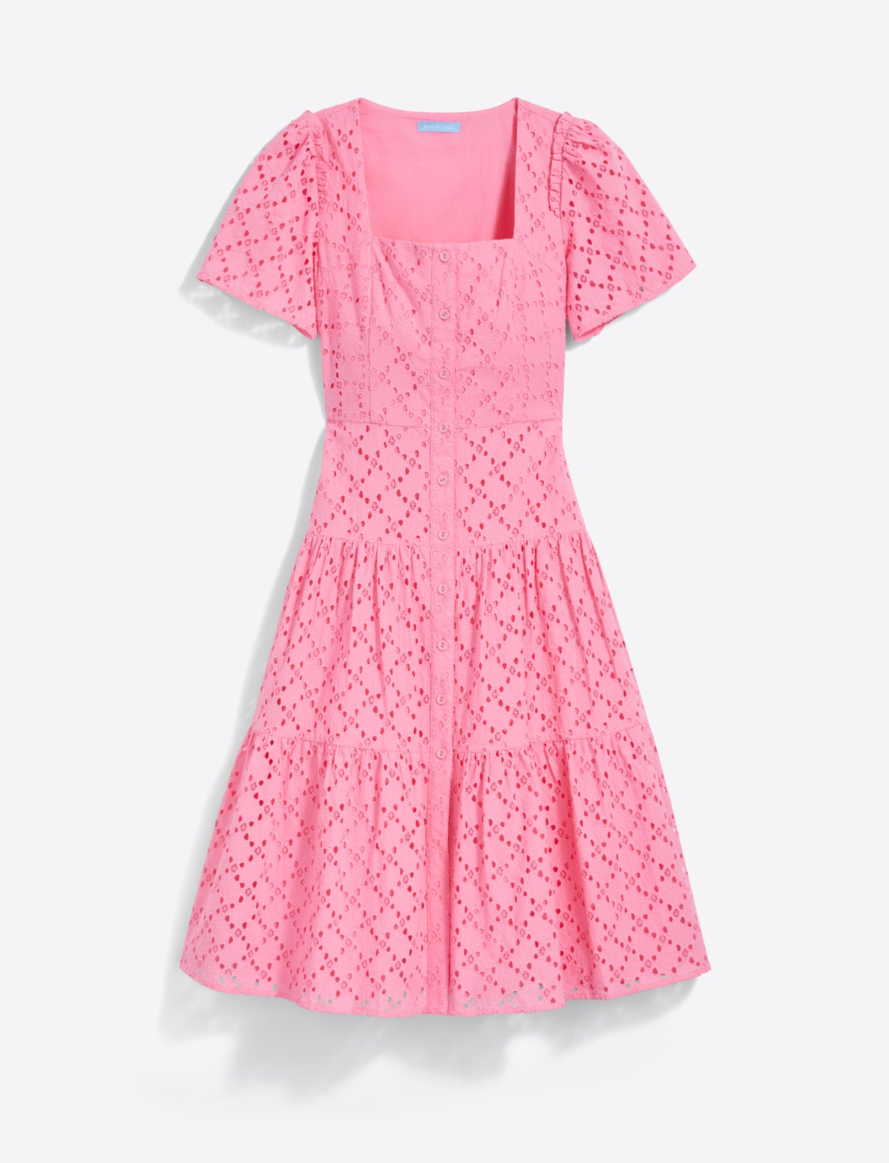 The Caitlyn Midi Dress in Eyelet by Draper James features a square neckline and short puff sleeves, crafted from pink cotton eyelet fabric with embroidery and a tiered skirt.