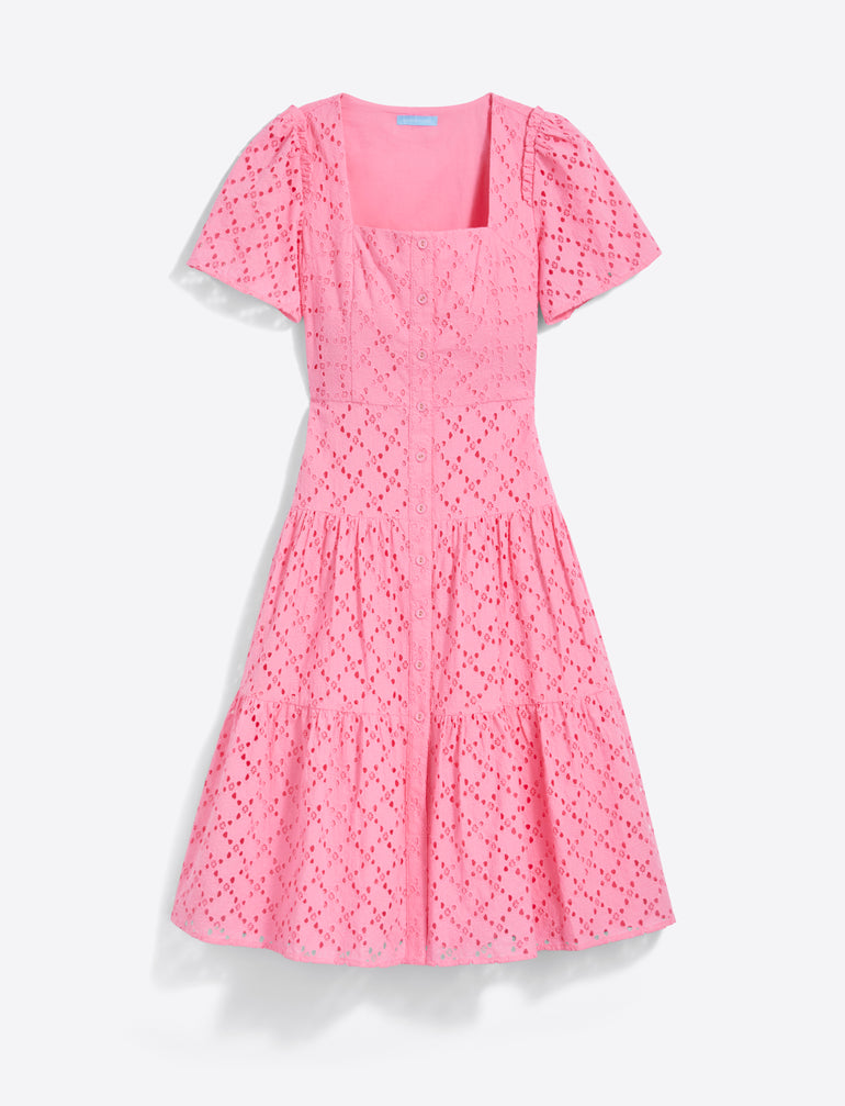 The Caitlyn Midi Dress in Eyelet by Draper James features a square neckline and short puff sleeves, crafted from pink cotton eyelet fabric with embroidery and a tiered skirt.