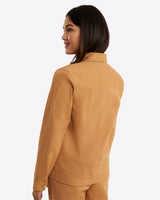 In a side view against a plain background, an individual is wearing Draper James' Utility Jacket in Cotton Twill.