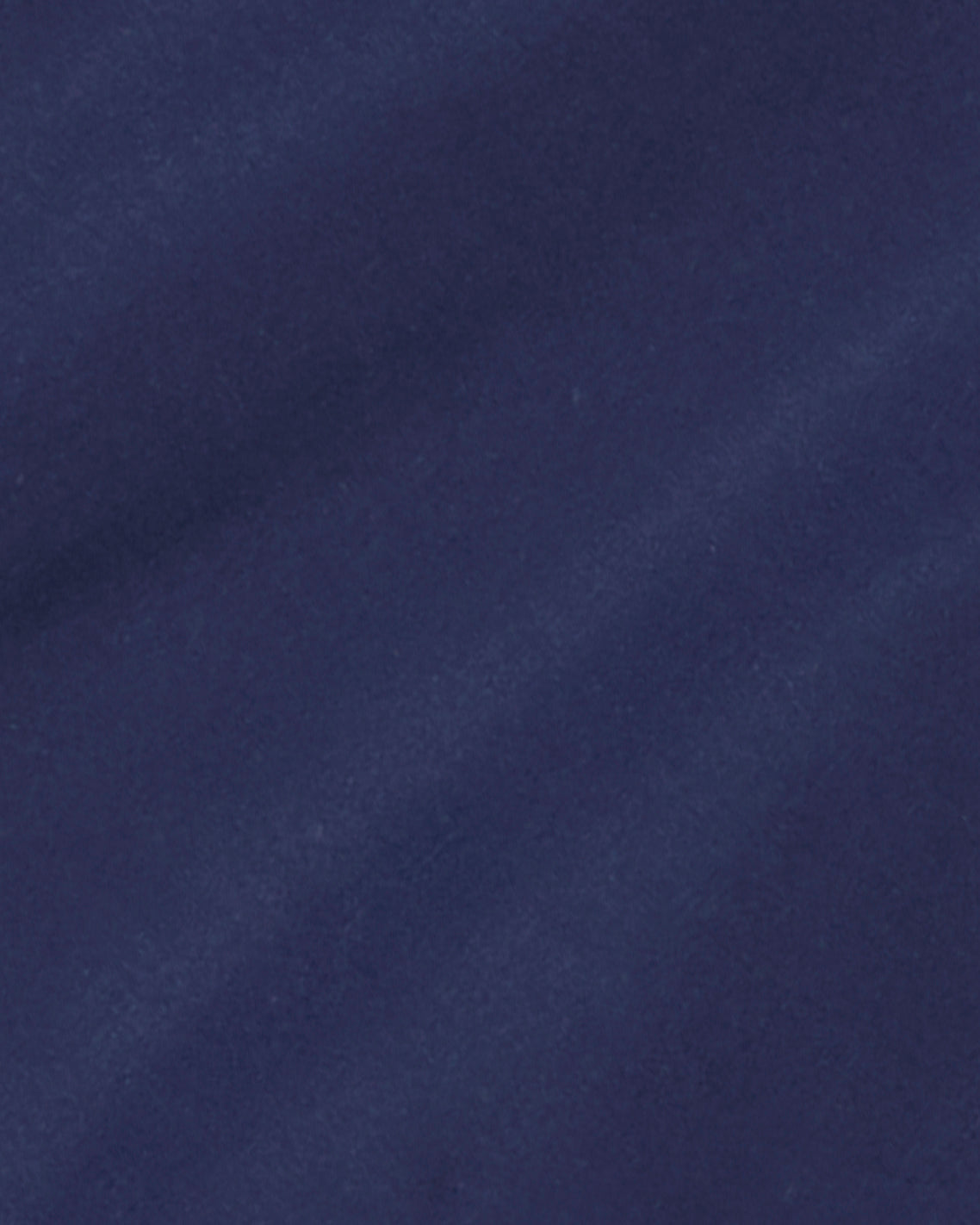 Close-up of a smooth, dark blue fabric with subtle diagonal shadows and soft texture, ideal for the classic silhouette of the Draper James Button Front Coat.