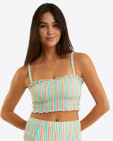 A woman with long dark hair wears the Draper James Smocked Bikini Topâ€”colorful, striped, with thin strapsâ€”paired with matching high-waisted bottoms against a plain light background. This seersucker set combines comfort and sunny-day style.
