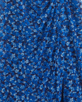 Close-up of the Selena V-Neck Midi Dress by Draper James, featuring blue stretch mesh with a dense scattered ditsy floral print and gathered draping.