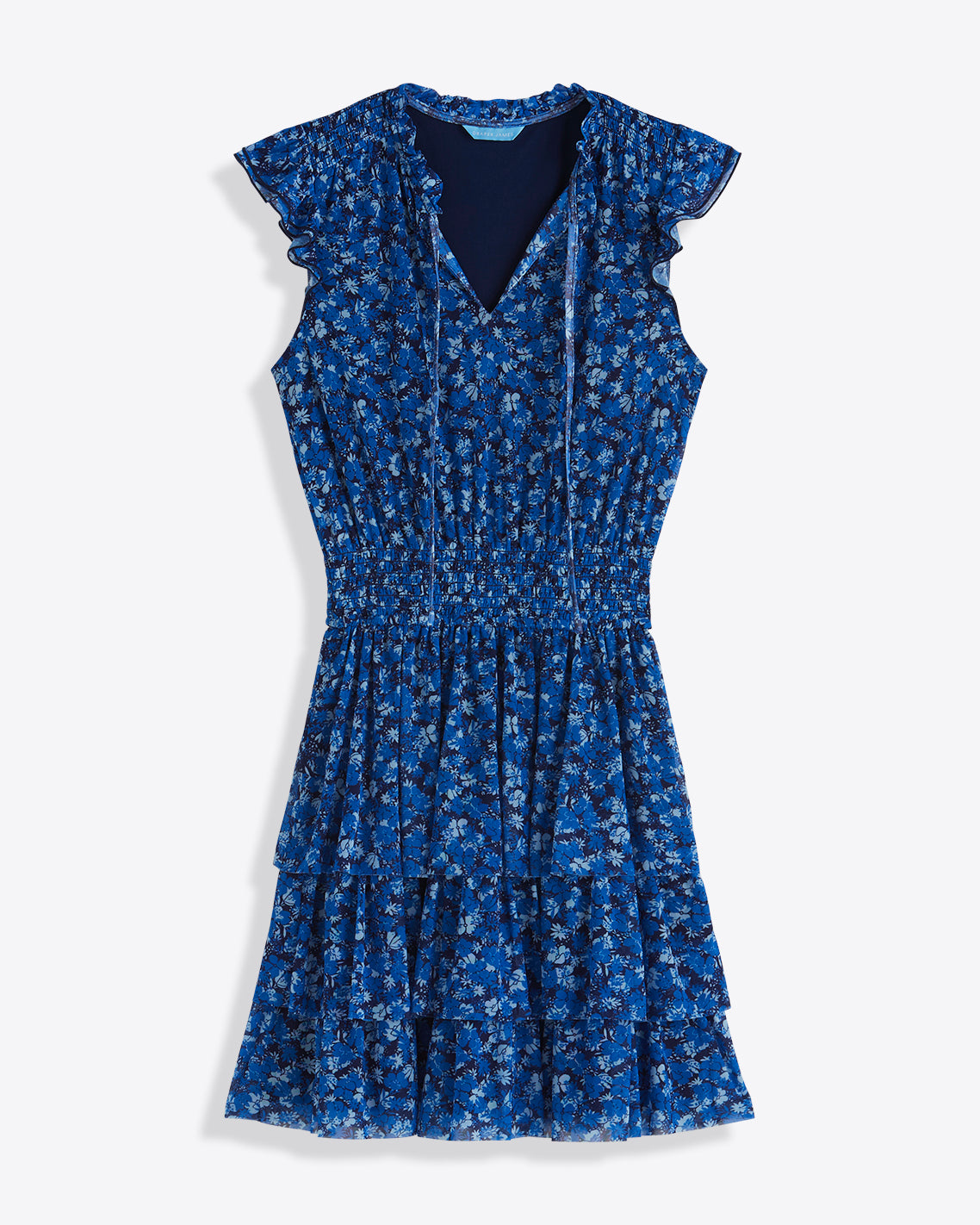 The Draper James Alana Tiered Dress in Blue Scattered Ditsy features a v-neck, ruffled cap sleeves, cinched waist, and tiered skirt, shown on a white background.