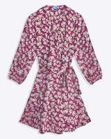 The Jordan Long-Sleeve Wrap Dress in Hammered Satin by Draper James features a pink base with white floral print, knee-length cut, wrap front, long sleeves, and a matching fabric waist tie.