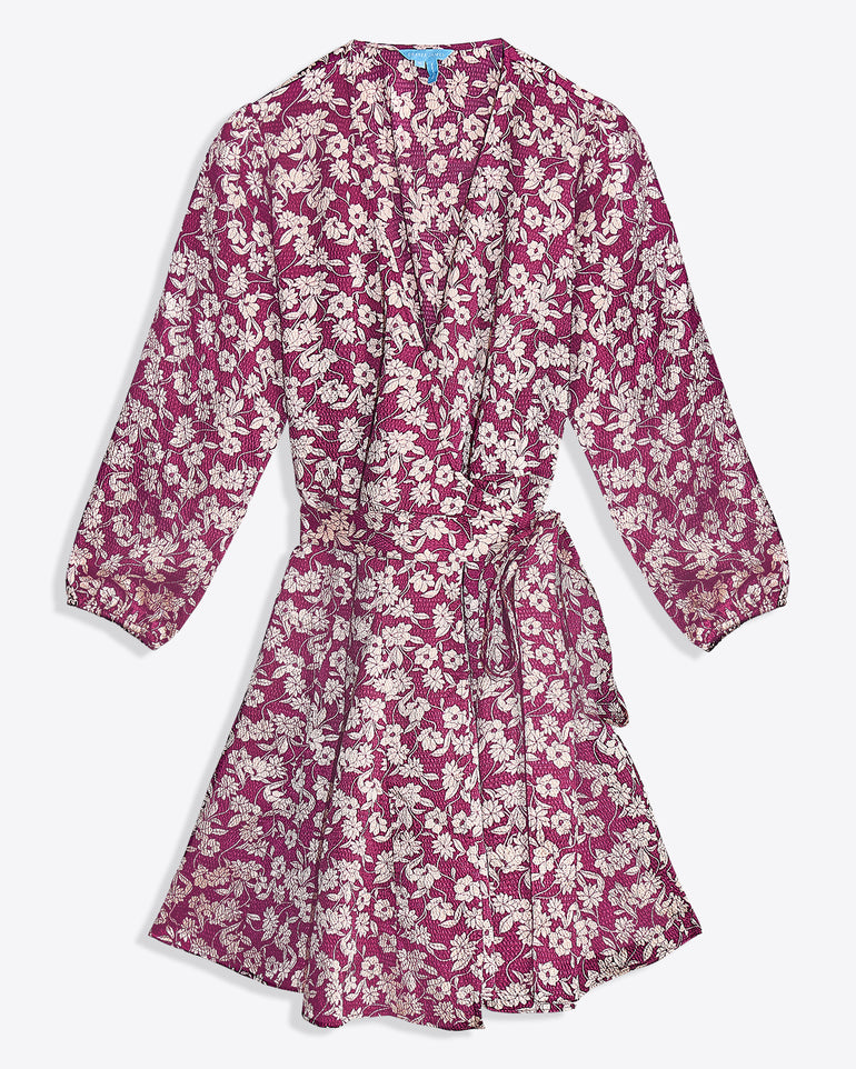 The Jordan Long-Sleeve Wrap Dress in Hammered Satin by Draper James features a pink base with white floral print, knee-length cut, wrap front, long sleeves, and a matching fabric waist tie.