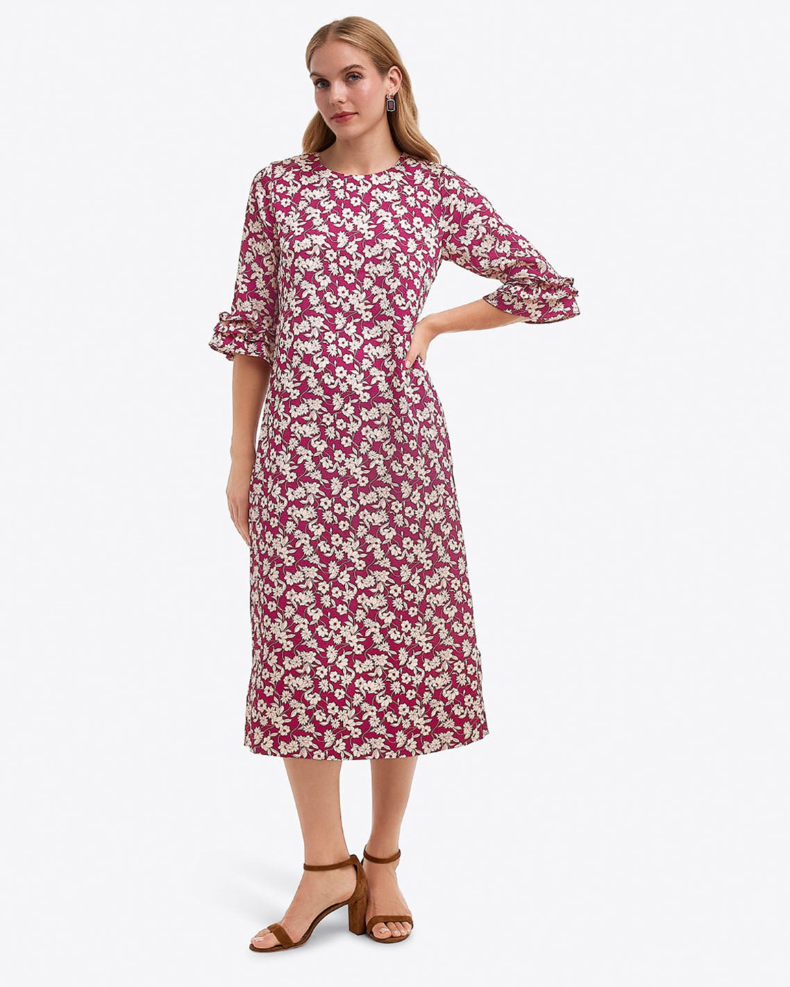 A woman models the Draper James Crewneck Midi Dress in Hammered Satin, featuring a maroon hue with white floral print and three-quarter ruffled sleeves, paired with brown ankle-strap sandals. Machine wash cold for best care.