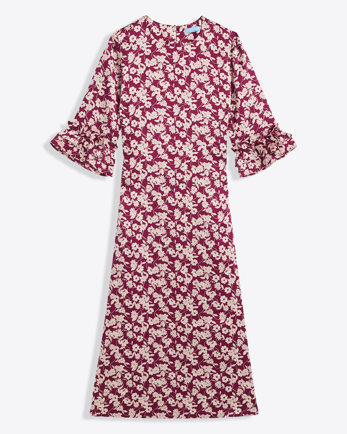 The Draper James Crewneck Midi Dress in hammered satin features a maroon and white floral pattern, ruffled cuffs, and a round neckline. Ankle-length with long sleeves. Machine wash cold for easy care.
