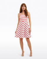 A woman wears the Zoe Love Circle Dress in Red Wentworth Stripe by Draper James, standing with one hand by her side and the other slightly extended against a plain white background.