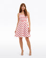 A woman wears the Zoe Love Circle Dress in Red Wentworth Stripe by Draper James, standing with one hand by her side and the other slightly extended against a plain white background.
