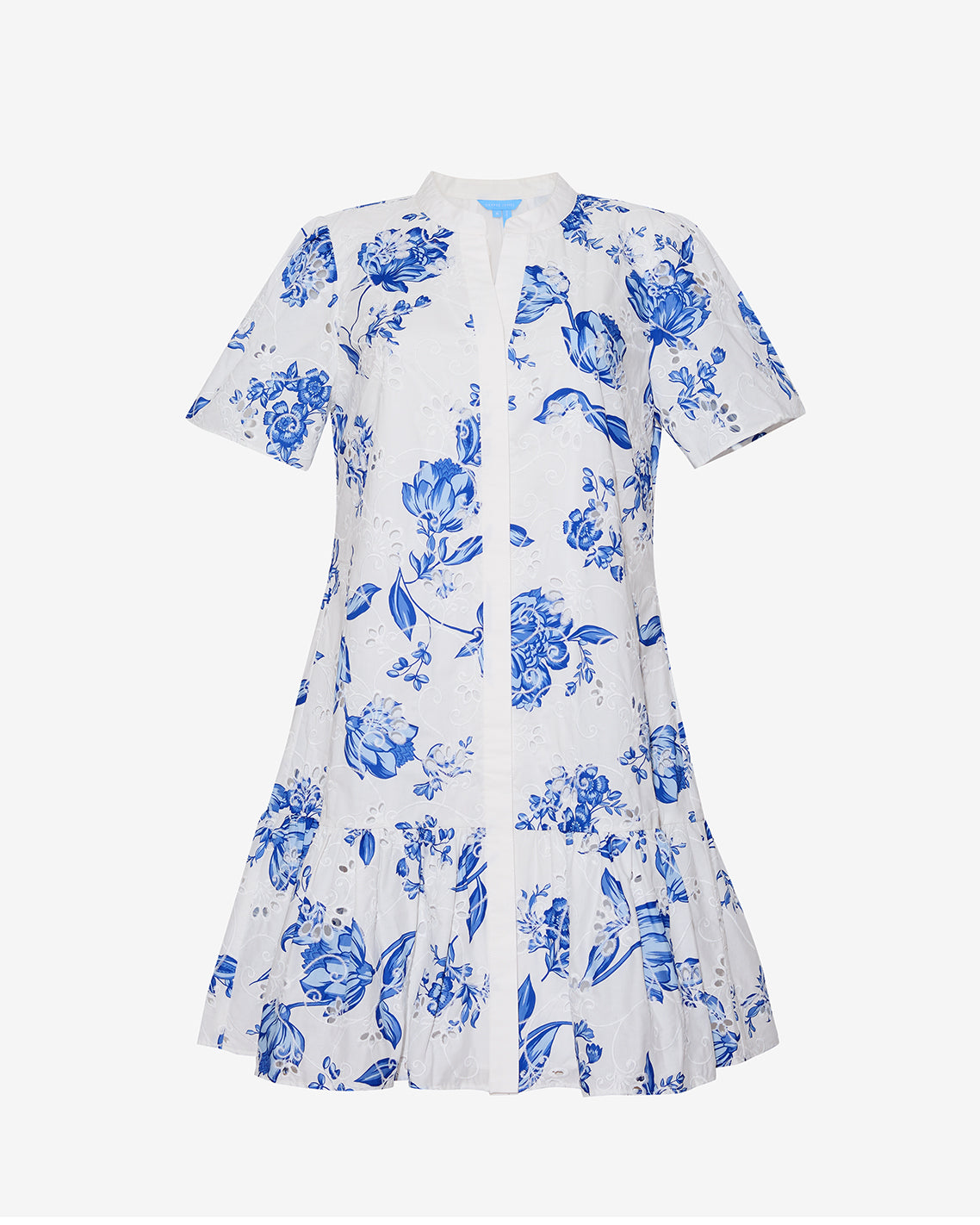 The Draper James Molly Mini Dress in Magnolia Toile is a white, short-sleeve 100% cotton dress with a blue floral print, fitted bodice, V-neckline, and flared ruffled hem.
