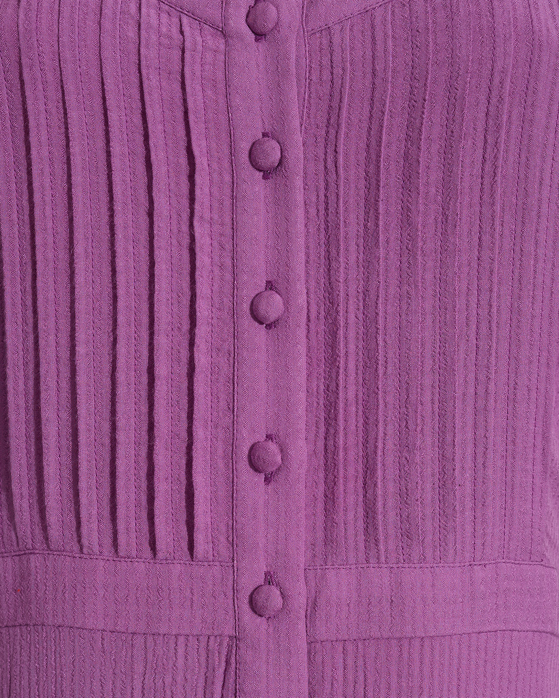 Close-up of the Draper James Brynn Sleeveless Midi Dress in Amethyst, a midi dress with vertical pleats and fabric-covered buttons down the front.