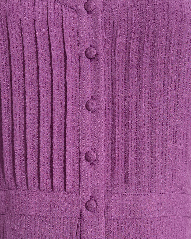 Close-up of the Draper James Brynn Sleeveless Midi Dress in Amethyst, a midi dress with vertical pleats and fabric-covered buttons down the front.