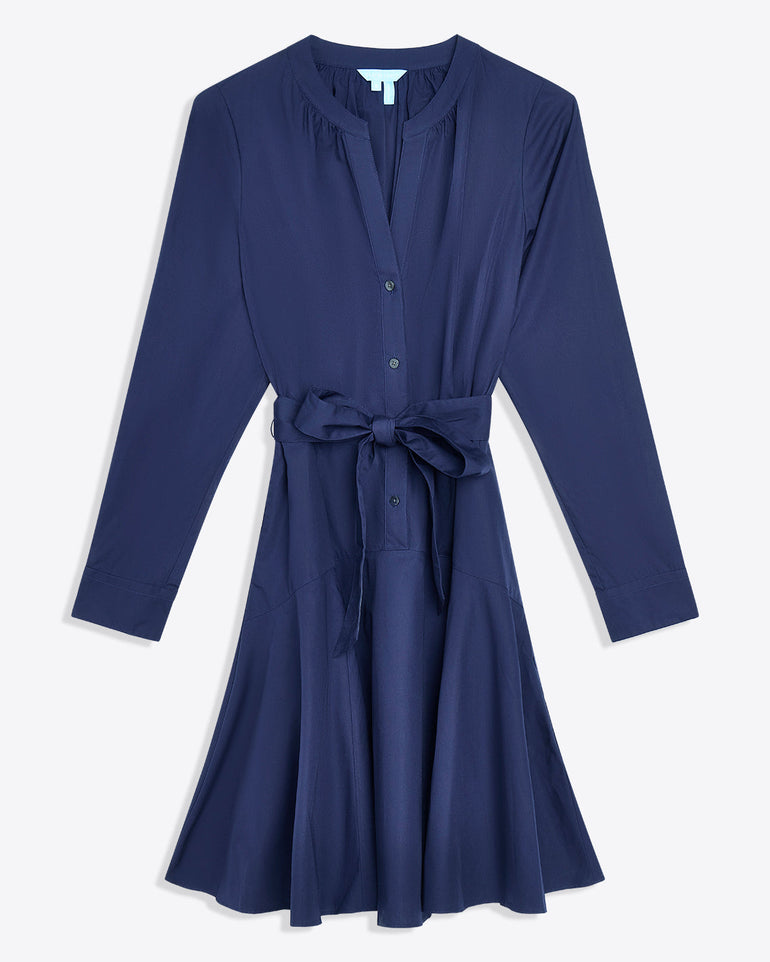 The Imogen Mini Shirtdress by Draper James features navy blue cotton, long sleeves, front buttons, a V-neckline, and a matching belt at the waistâ€”perfect as a chic work dress.