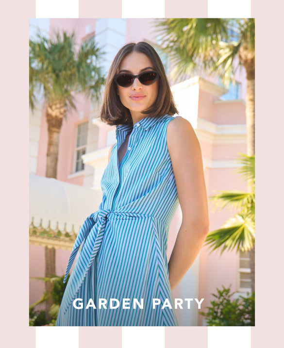 Woman in a blue striped dress with sunglasses against a palm tree background