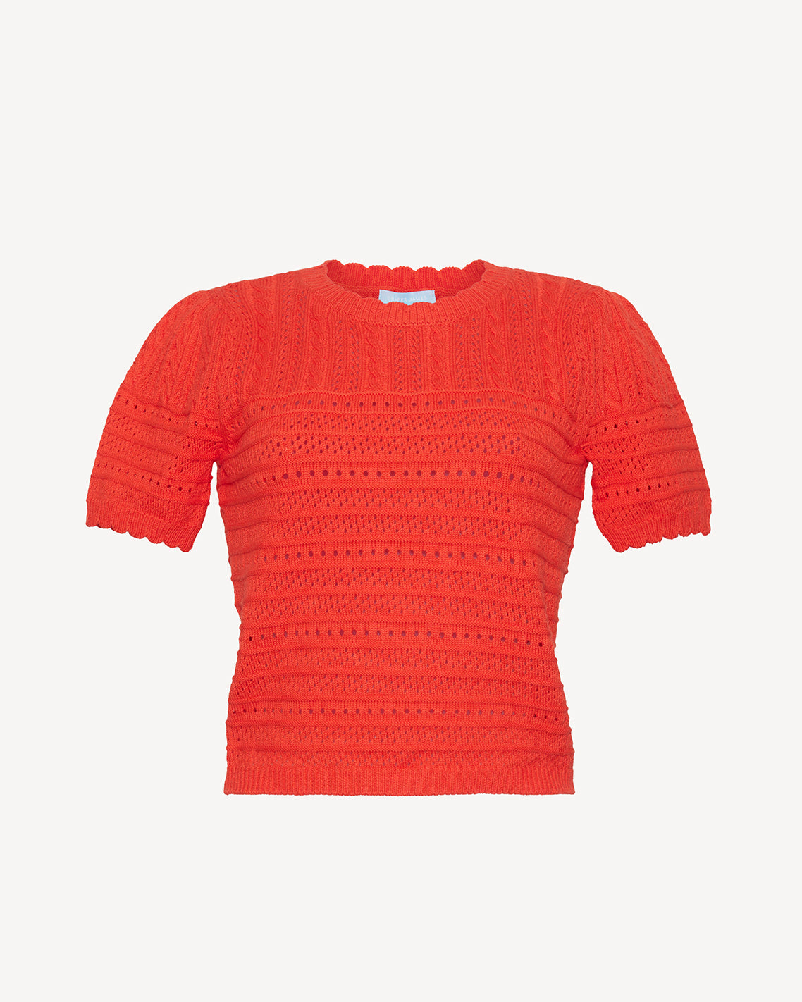 The Draper James Short Sleeve Pointelle Sweater features a round neckline, bright red hue, and textured openwork design, crafted from lightweight cotton for breathable comfort.