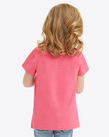 A young child with curly hair, dressed in a Draper James Kids WWDD Pink T-Shirt made of soft Jersey Cotton, is seen from behind.