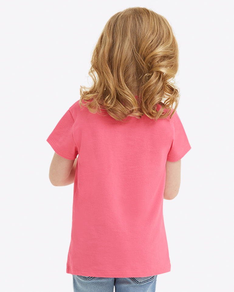A young child with curly hair, dressed in a Draper James Kids WWDD Pink T-Shirt made of soft Jersey Cotton, is seen from behind.